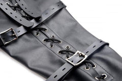 Close-up of black faux-leather armbinder showing lace-up cord detail and metal buckles