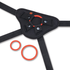 Close-up of black harness front panel with snap closures and two red silicone O-rings beside it