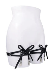 Black laced garters worn on mannequin lower torso showing front bow and clip placement