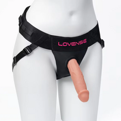 Black Lovense harness worn on mannequin with realistic dildo inserted through O-ring