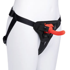 Black nylon strap-on harness worn on mannequin with red curved silicone dildo attached