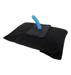 Black pillow protector with attachment panel holding teal toy accessory upright on pillow