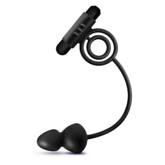 Black silicone anal plug connected by flexible tether to vibrating bullet and circular cock ring