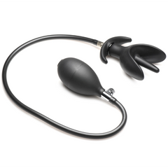 Black silicone anchor anal plug connected to soft pump bulb via flexible tubing, side angle view