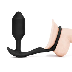 Black silicone b-Vibe Snug & Tug cock ring shown fitted on a model for scale reference