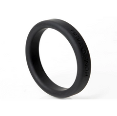Close-up of black silicone cock ring showing smooth rounded edges and brand text