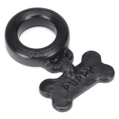 Black silicone cockring with textured ring and dangling Puppy bone pendant, rear angle