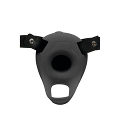 Close-up of black silicone hollow sheath base with snap-attached leather harness straps