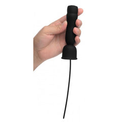 Black silicone penis head teaser held in hand, showing ribbed handle and flexible urethral insert