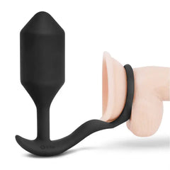 Black silicone plug and ring combo shown alongside anatomical model for fit reference