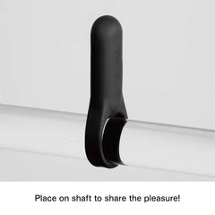 Black silicone vibrating ring placed on cylindrical shaft showing flexible ring positioning