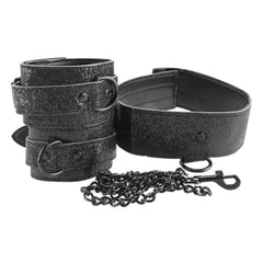 Close-up of black sparkle collar, double-strap wrist cuffs, and dark metal chain connector clasp