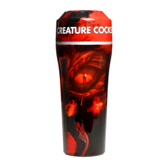 Black stroker case with vivid dragon-eye artwork and Creature Cocks branding wrap around exterior