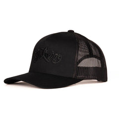 Black-on-black trucker cap three-quarter view displaying deep puff embroidery detail and mesh contrast