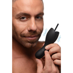 Close-up of black vibrating head teaser held in hand, showing flexible silicone body and sound tip