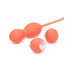Bloom Kegel Exerciser disassembled revealing interchangeable coral silicone weighted balls