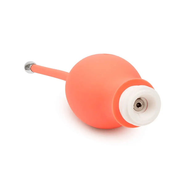 Close-up of Bloom Kegel Exerciser magnetic charging port on smooth coral silicone ball