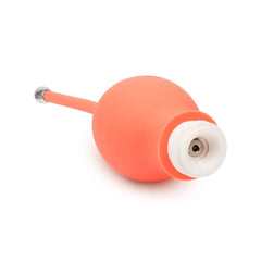 Close-up of Bloom Kegel Exerciser magnetic charging port on smooth coral silicone ball