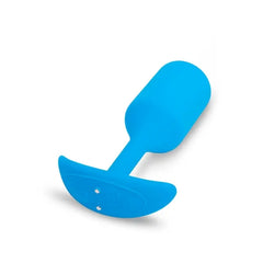 Blue silicone anal plug tilted to show magnetic charging ports on the flat anchor base