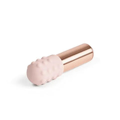 Blush pink dotted silicone sleeve on Le Wand Bullet shown at a resting angle