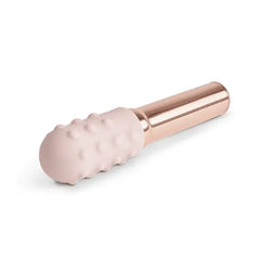 Blush pink textured silicone sleeve on Grand Bullet shown at an angle revealing raised dot pattern