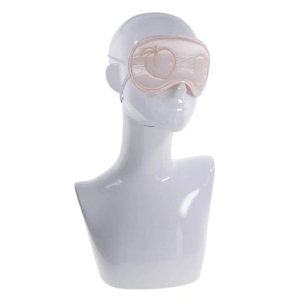 Blush satin blindfold displayed on white mannequin head showing fit and coverage area