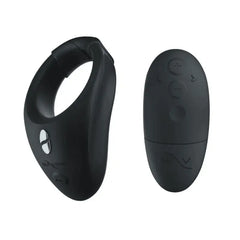 Bond cock ring beside oval wireless remote, both in smooth matte black silicone