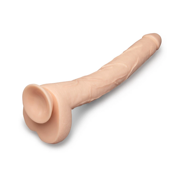 Bone 17-inch dildo laid at angle showing suction cup base stability and flexible body