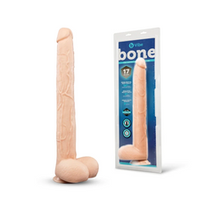Bone deep-insert dildo beside its retail packaging showing product specs and dimensions