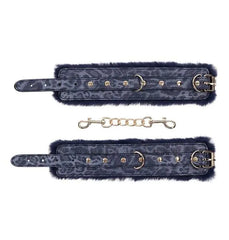 Both navy fur cuffs unclasped and laid flat beside detachable gold link connecting chain