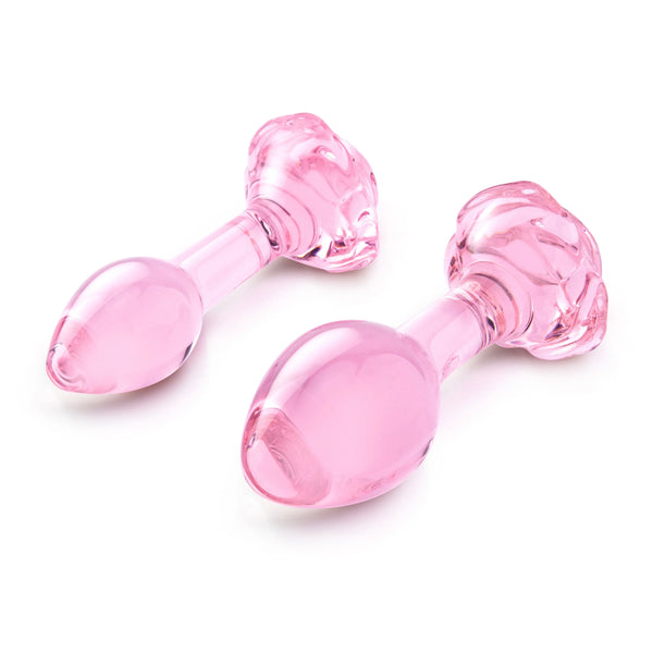 Both pink glass plugs laid at an angle showing bulb tips and rose bases from above