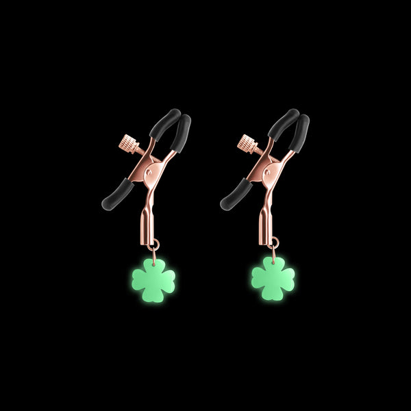 Bound G4 Rose Gold nipple clamps with black tips and glow-in-the-dark four-leaf clover charms