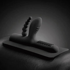 Buckwild silicone attachment with beaded and ridged shafts displayed on a dark leather surface