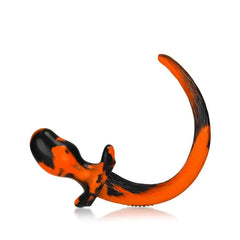Bulldog butt plug with curved tail, orange-black blend, showing base grip detail from rear angle