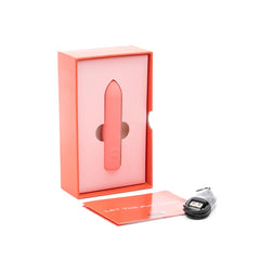 The Bullet vibrator unboxed beside USB charging cable and instruction booklet