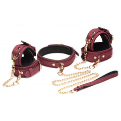 Burgundy velvet bondage set laid flat showing collar, wrist cuffs, ankle cuffs and gold chain leash