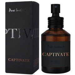 Captivate eau de parfum spray bottle with black pump cap next to dark packaging