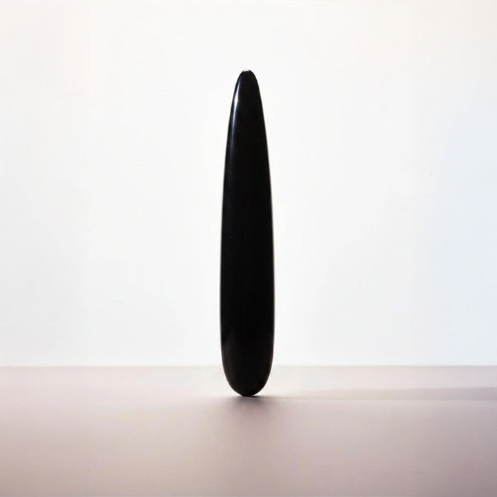 Chakrubs Xaga Slim obsidian wand standing upright, sleek tapered black stone form