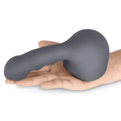 Charcoal grey Ripple silicone attachment resting on open palm, showing soft texture