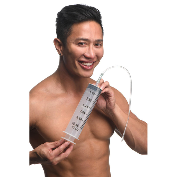 CleanStream 300ml Enema Syringe with flexible silicone tube held by smiling male model