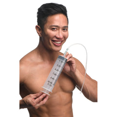 CleanStream 300ml Enema Syringe with flexible silicone tube held by smiling male model