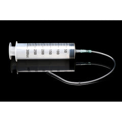 CleanStream syringe with curved silicone tube attached, shown on reflective black surface