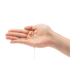 Clear organic lubricant pooled in an open palm, showing smooth, lightweight texture