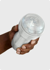 Clear Pocket Stroker Crystal sleeve held in hand, showing star-shaped entry point and internal crystal texture