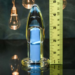Clear vibrating plug beside ruler showing approximately 4-inch insertable length