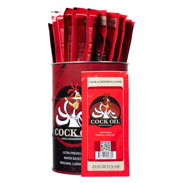 Cock Oil lubricant drum display with 25 red foil sample packets, single packet shown front