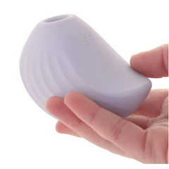 Compact lavender silicone Pearl Diver stimulator resting in a hand showing its palm-sized scale