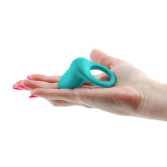 Compact teal INYA Regal vibrating ring shown resting in an open palm for scale