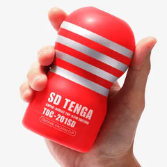 Compact Tenga SD Original Vacuum Cup held in one hand showing its palm-friendly size