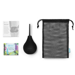 Complete b-Vibe enema set laid flat: bulb, mesh storage bag, and two guide booklets
